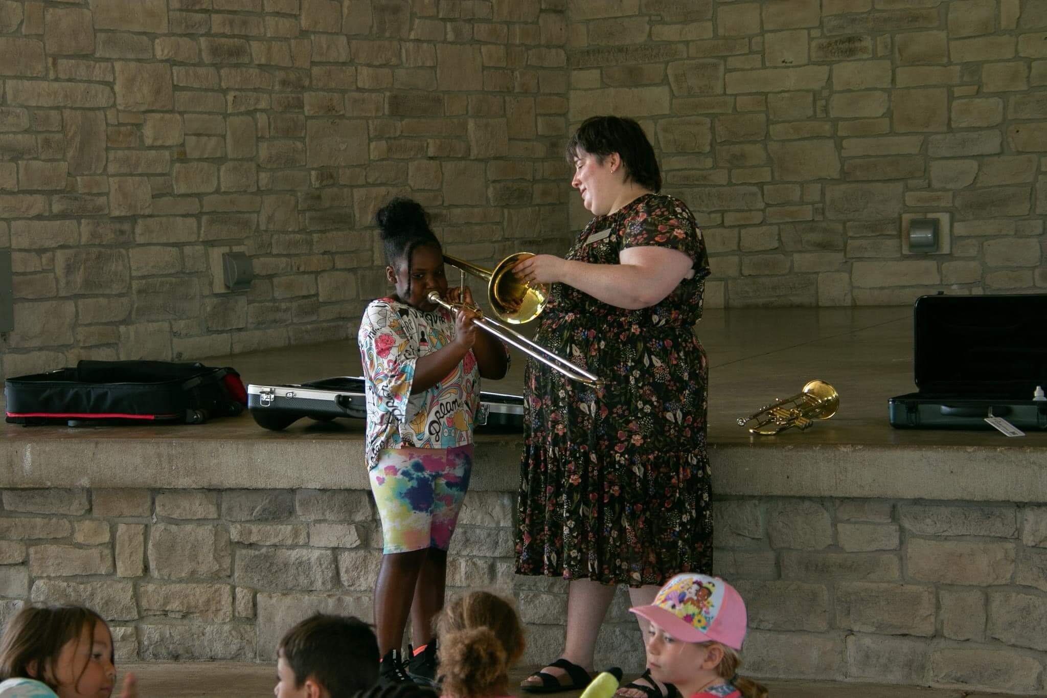 Kids playing a trombone at Valpo Creates Camp 2023